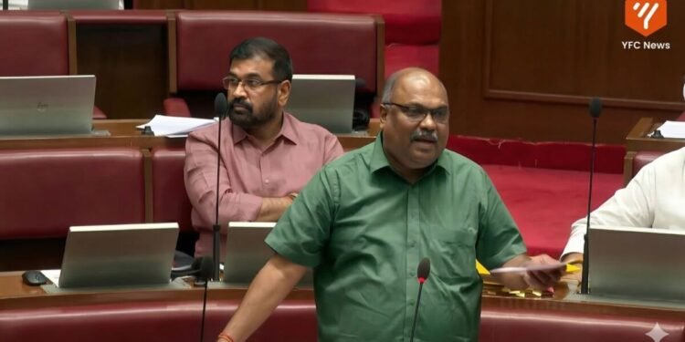 Man passing along documents in front of audience discussing religion freedom bill.